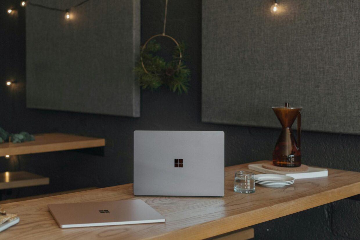 A Microsoft laptop on the desk.